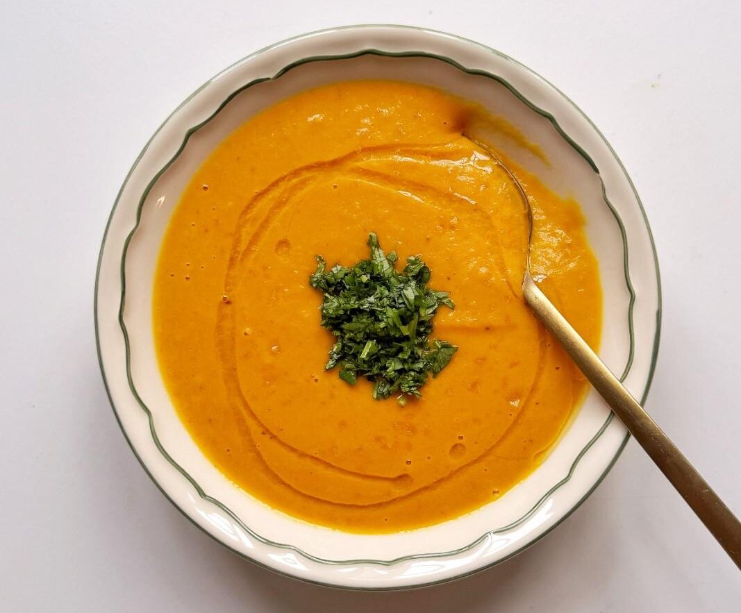 Bright orange carrot ginger soup with coconut milk.