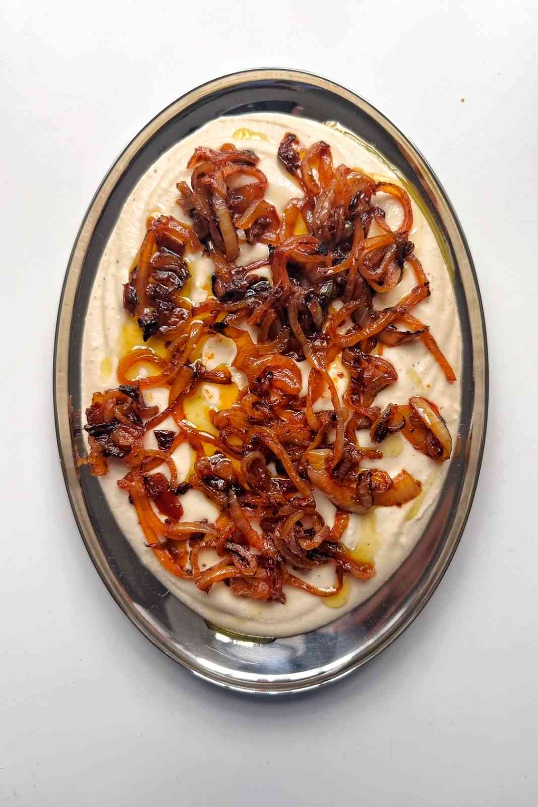 Smooth white bean dip topped with spiced caramelized onions.