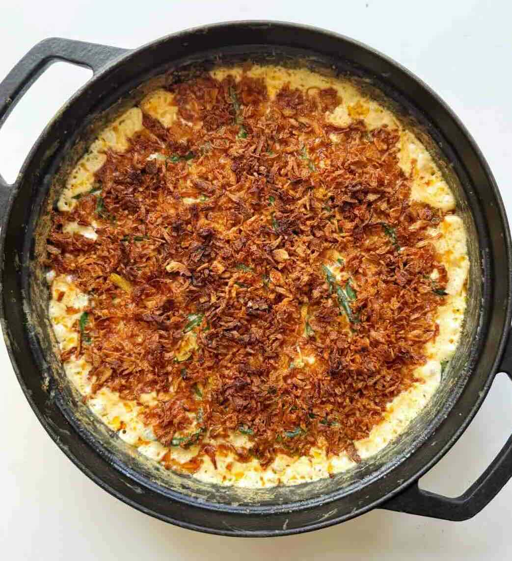 Creamy Green Bean Casserole without Mushroom Soup in a black pan.