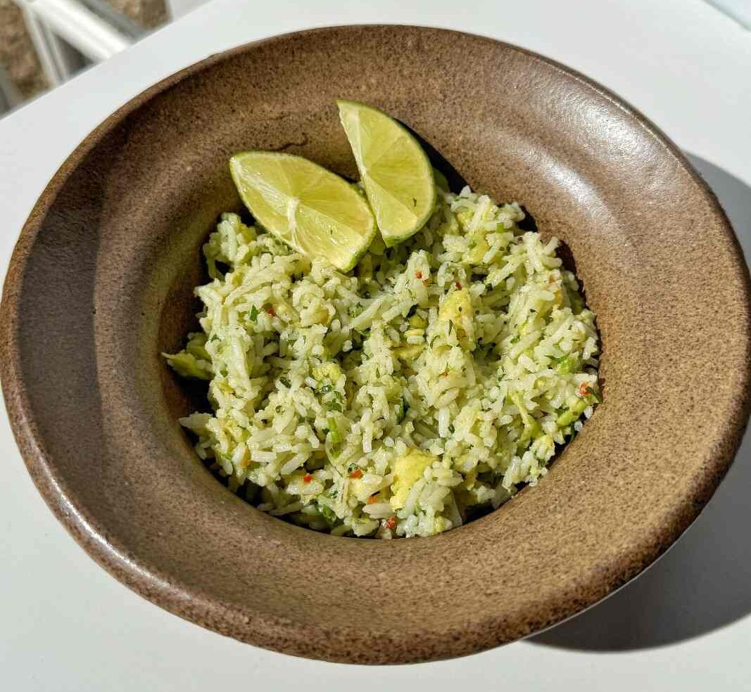 Quick and easy Avocado Rice in a brown stone bowl.