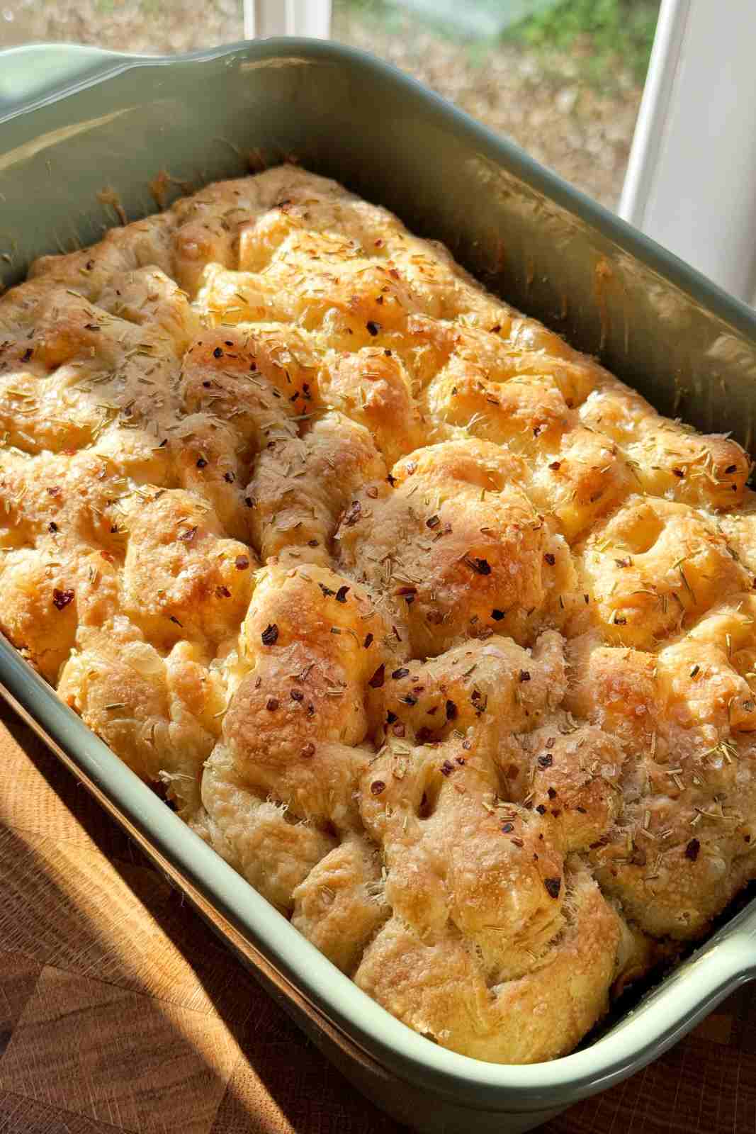 A baking tray full of fluffy airy easy focaccia.