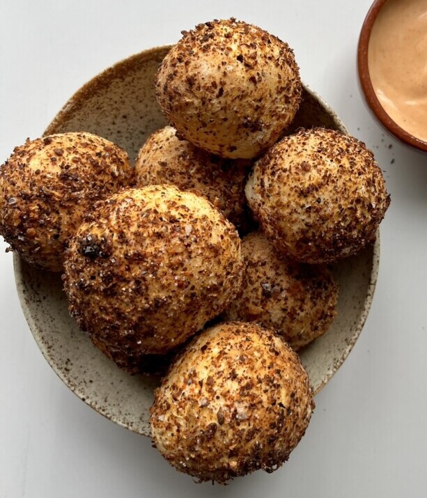 A small bowl of 2 ingredient bread bites covered in chili flakes.